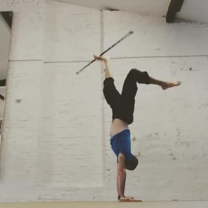Circus Artist Spins Staff Over His Feet