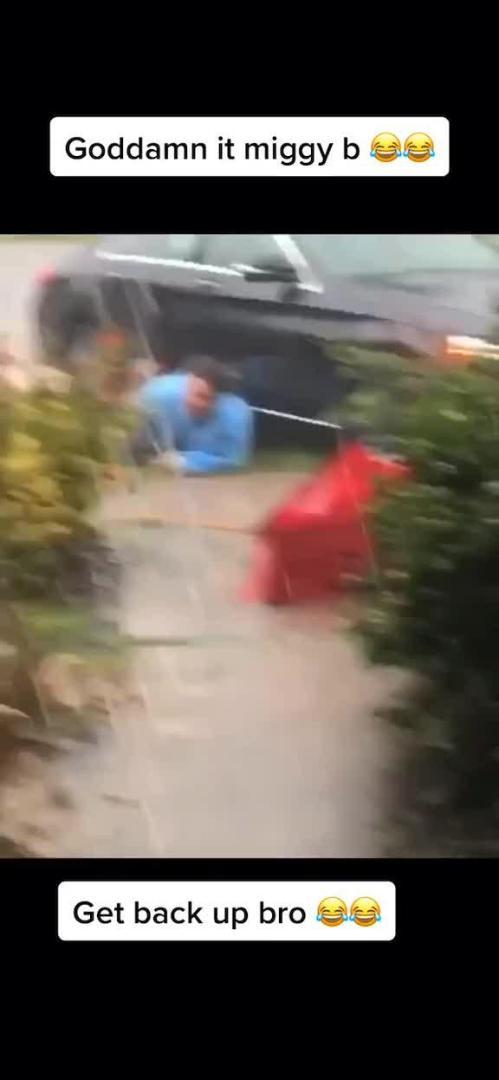 Guy Slips and Falls While Running in the Rain