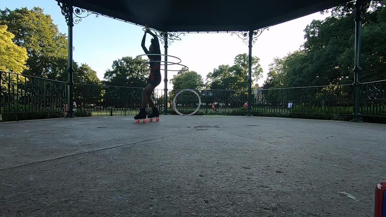 Girl Does Amazing Hula Hoop Tricks While Rollerskating