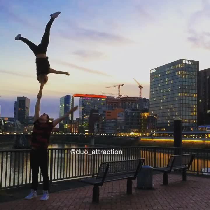 Guy Balances Girl on Both Hands While she Does Handstand