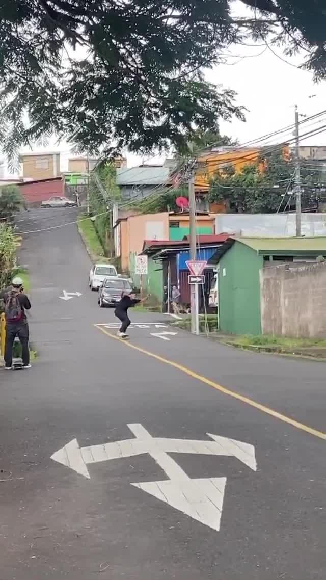Guy Crashes Into Moving Car While Skateboarding on Downslope