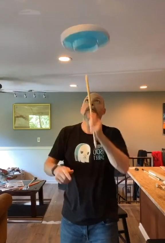 Guy Juggles Spinning Plate Between Stick and his Finger