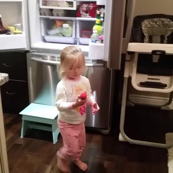 Little Girl Gets Caught Red Handed While Sneaking Drink From Refrigerator