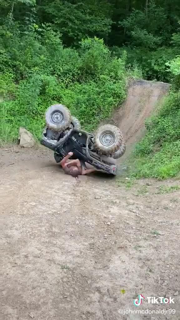 Man Flips Back While Driving ATV on Slope and Falls Hard on Ground