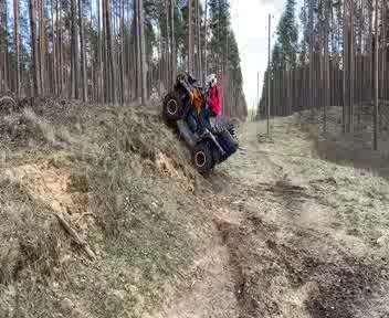 Man Riding Quad Bike Falls Back While Trying to Drive it Over Slope