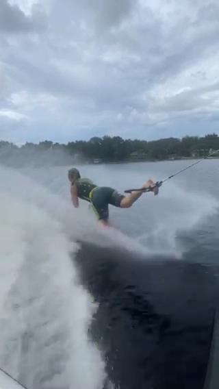 Girl Performs Tricks While Waterskiing Barefoot